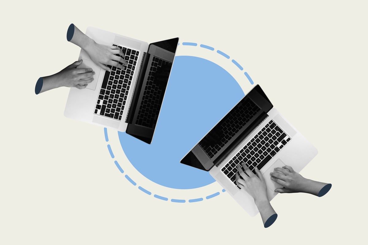 Business professionals collaborating on laptops